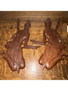 Hand-carved Thai wooden plaques depicting musicians playing stringed instruments